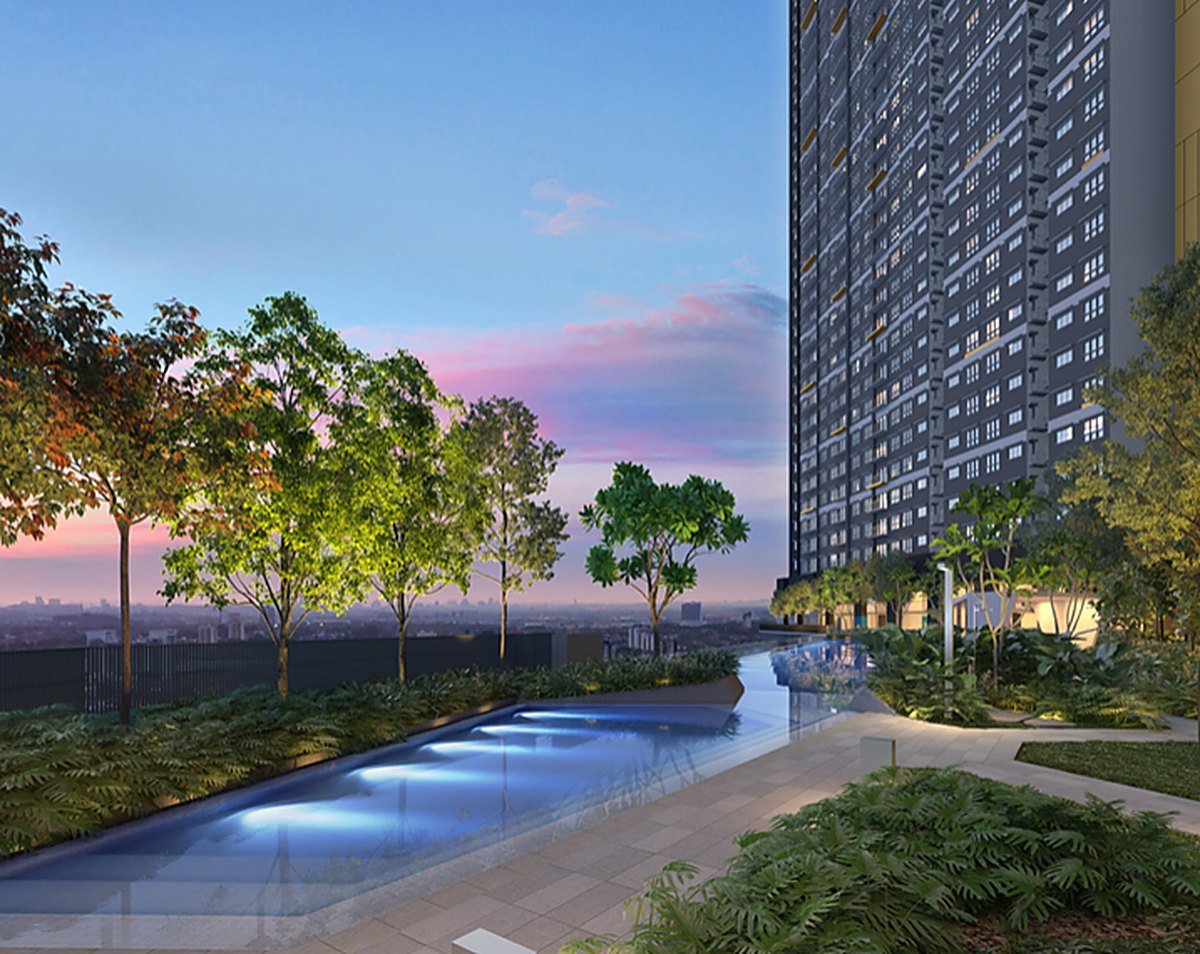 The Wyn Residences Puchong landscaped swimming pool and deck at dusk with the towers behind