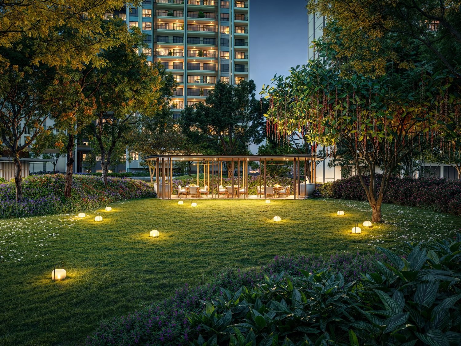 Zenia ParkCity Damansara evening linear park with lit garden bollards and a tower beyond